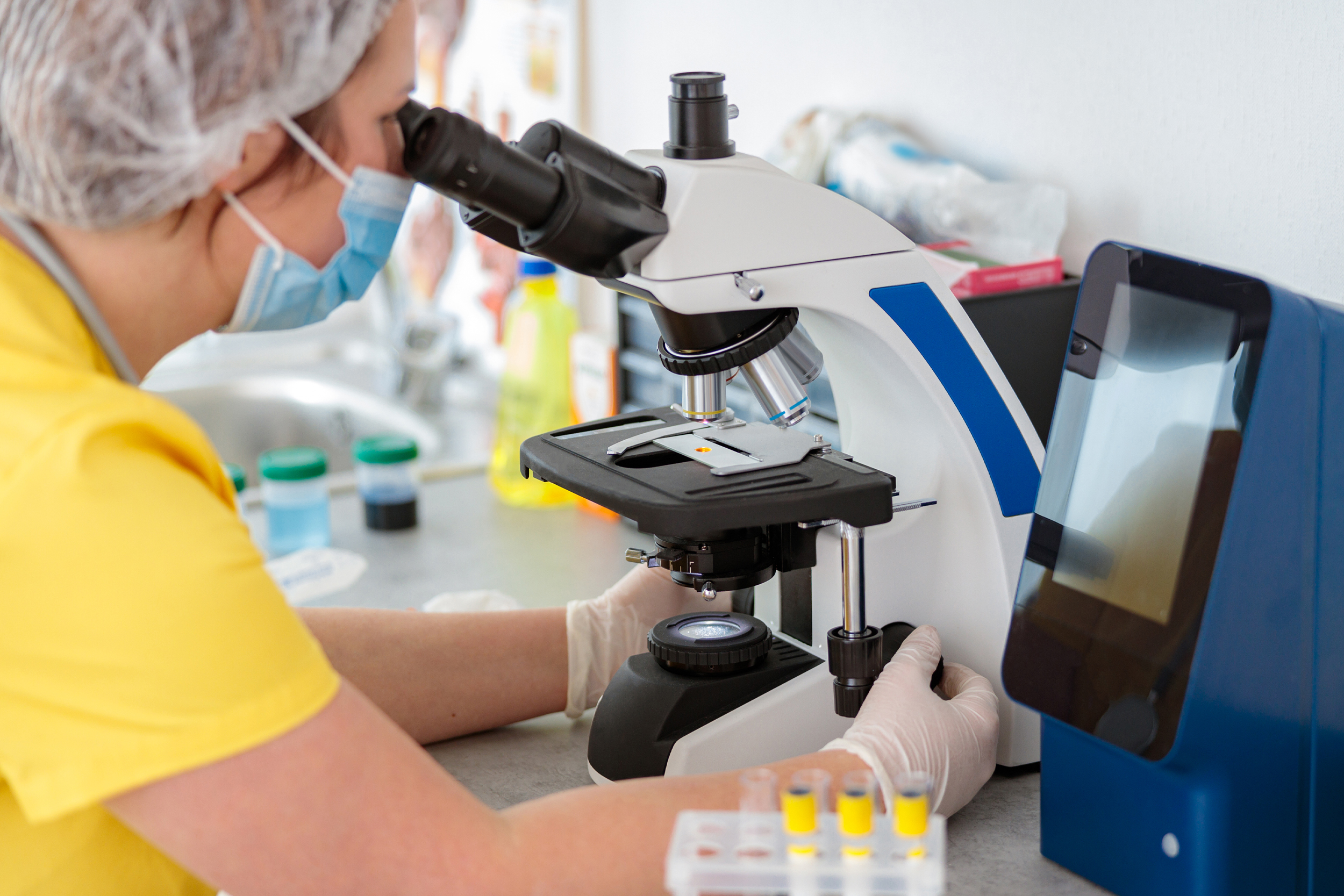 Staff examining microscope